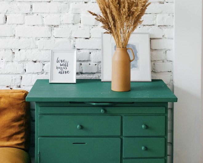 aesthetic drawers with vase and picture frames on top